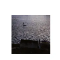 The photo shows a stand-up paddleboarder on the enormous Danube river in the cold of November. They appear small, vulnerable, isolated, and exposed. While the river itself is not inherently hostile, its scale, the cold season, and the absence of other people create a sense of precariousness.